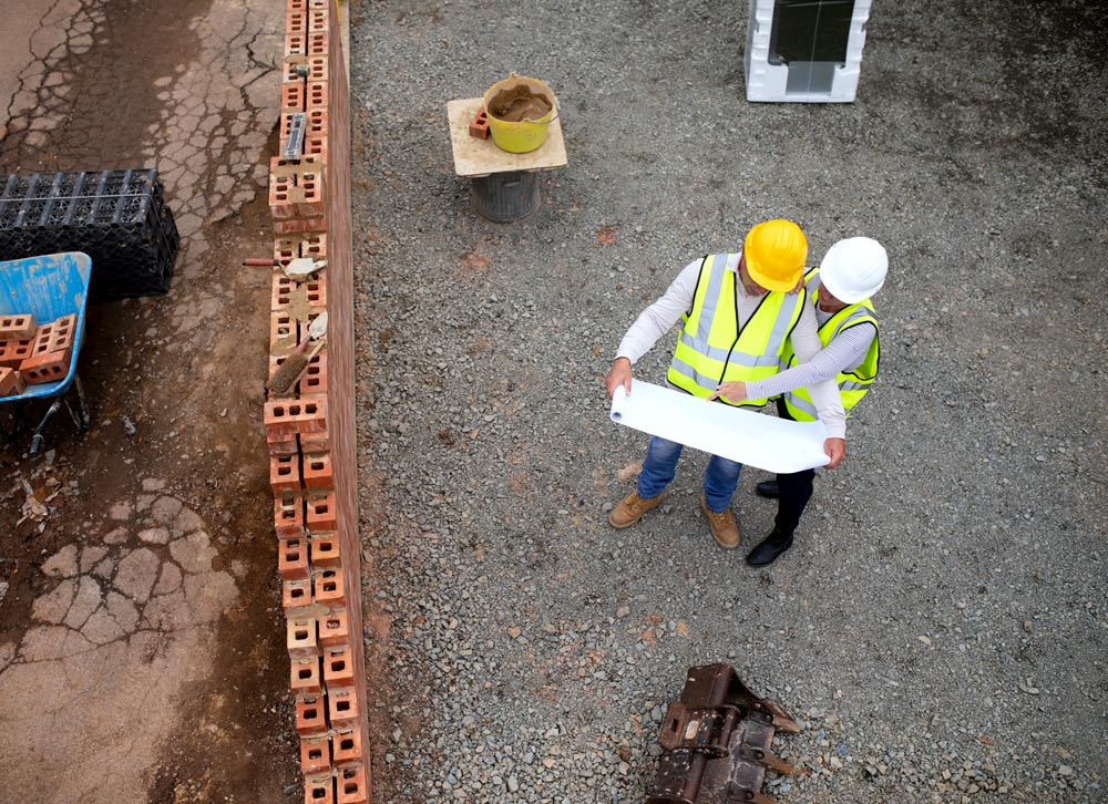 SMconstruction-workers-reviewing-plans-at-constructi-2026-03-18-16-03-08-utc